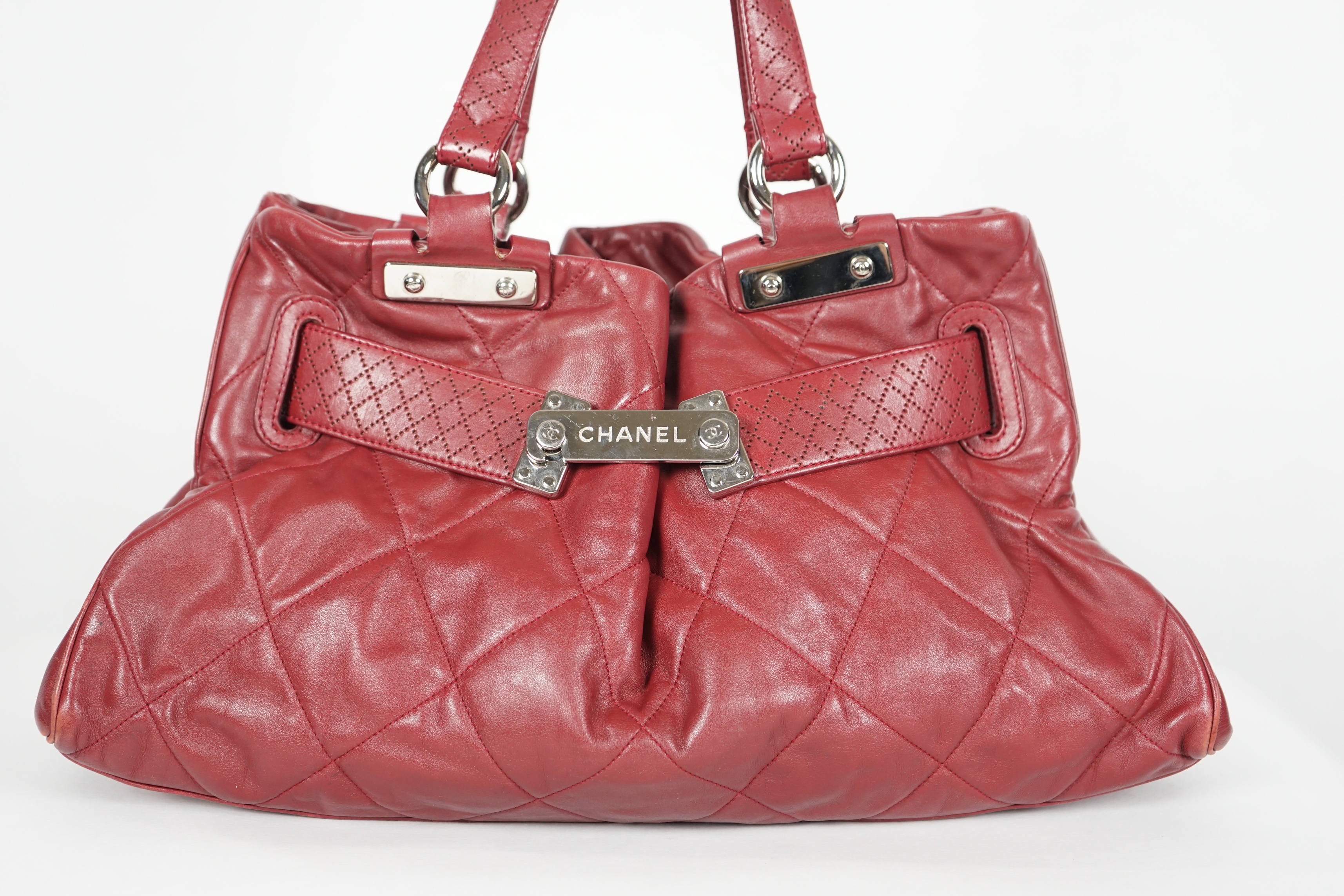 A Chanel burgundy leather buckled handle bag, with dust bag, height: 24.5cm, height overall 44cm, width 45cm, depth 16.5cm, Please note this lot attracts an additional import tax of 20% on the hammer price